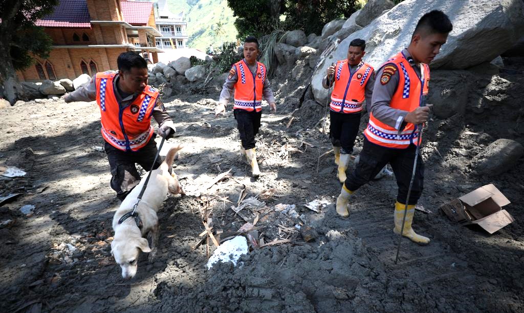 Petugas kepolisian mengerahkan anjing pelacak dalam melakukan pencarian jenazah korban banjir bandang di Kabupaten Humbang hasundutan.(BNPB)