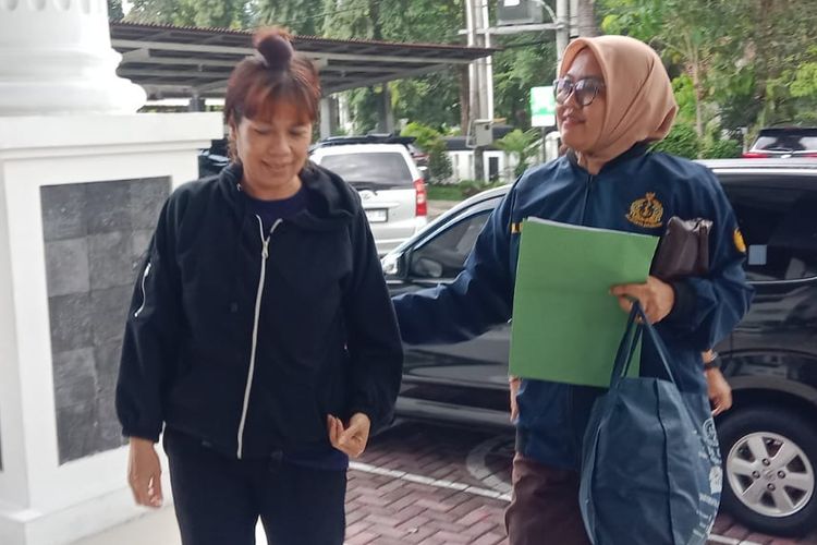Sophia Loretta Hutabarat (kiri), buronan kasus investasi bodong berkedok trading forex, saat dibawa ke Kejari Kabupaten Magelang, Selasa (20/2/2024).Kompas.com
