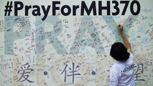 Seorang kerabat menuliskan doa dan harapannya untuk penumpangan MAS MH370. (Reuters/Samsul Said)