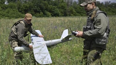 Dua orang tentara Ukraina sedang berupaya melepas landaskan drone di wilayah Donetsk 27 Juni 2023. (AFP/GENYA SAVILOV)