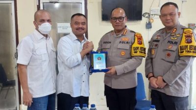 Ketua PWI Sumut H Farianda Putra Sinik SE menyerahkan plakat kepada Kapolrestabes Medan, Kombes Pol Gidion Arif Setyawan.(ist)