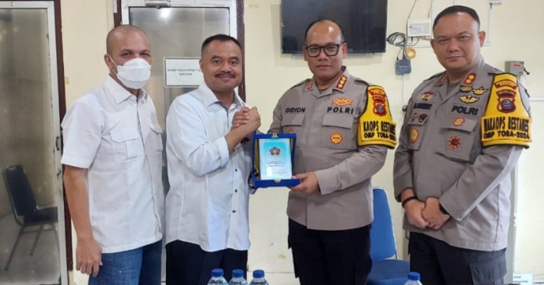 Ketua PWI Sumut H Farianda Putra Sinik SE menyerahkan plakat kepada Kapolrestabes Medan, Kombes Pol Gidion Arif Setyawan.(ist)