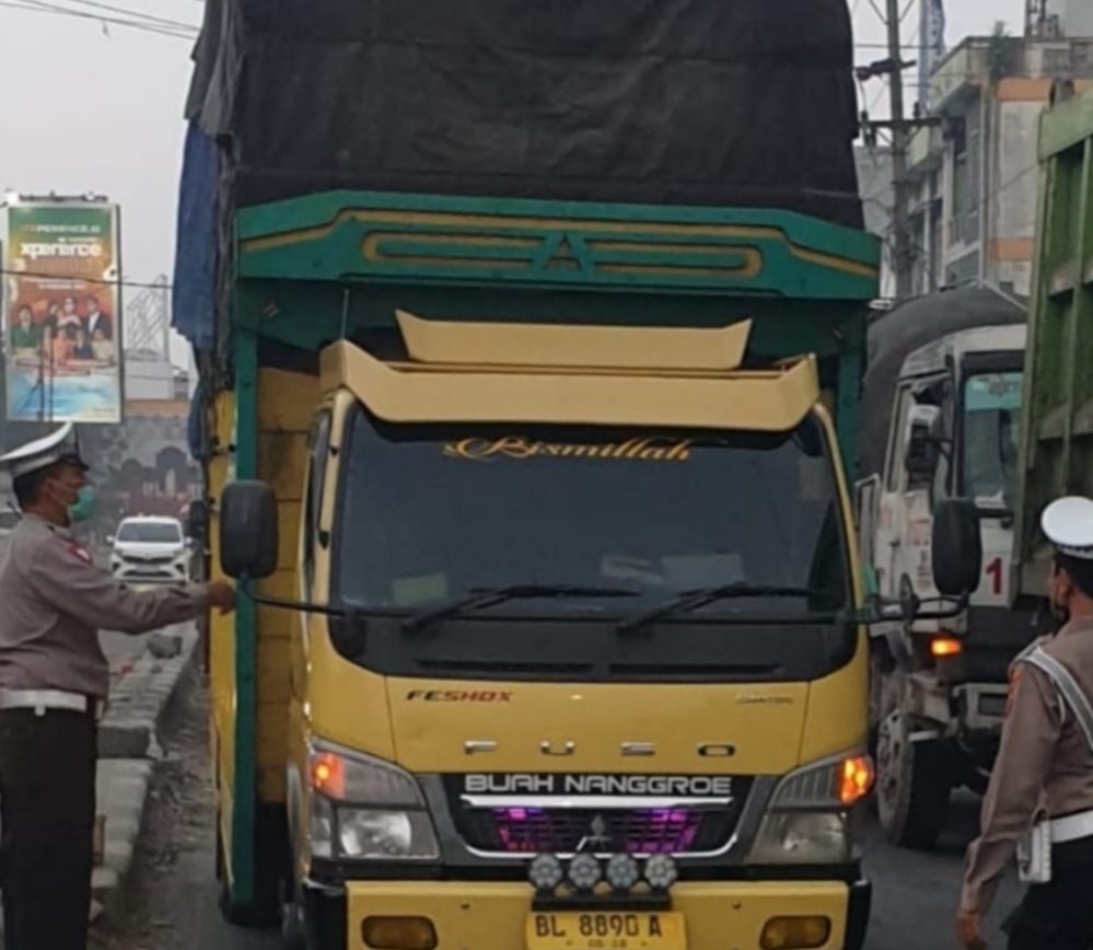 Polisi menyetop truk syarat muatan.(ist)